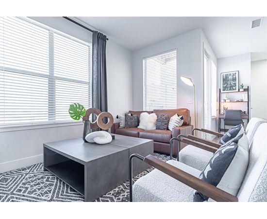 a living room with a leather couch and a coffee table at RockVue, Broomfield, Colorado